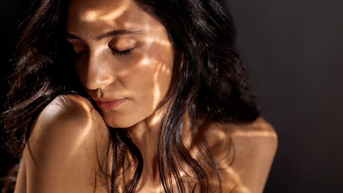 A woman with light reflections playing on her skin
